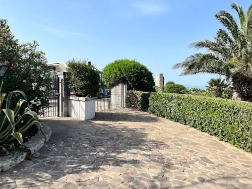 a stone walkway with a gate and a fence at Villa Sebastian- Incomparabile vista sul mare in Siracusa