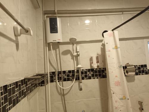 a shower in a bathroom with a glass door at Cana Boutique Hotel in Bangkok