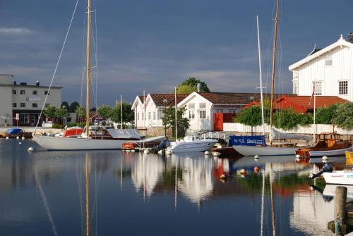 boats are docked in a harbor at Gjestehuset IBSEN in Grimstad