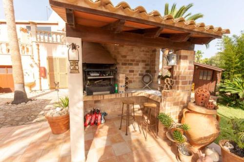 a patio with an outdoor kitchen in a house at Casa Romantica in Sa Coma
