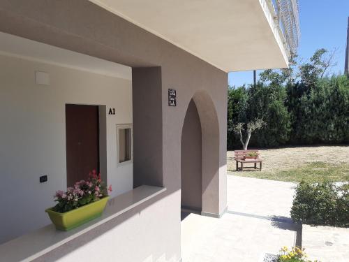a building with a flower pot on the side of it at Villa Nonno Nicola in Montenero di Bisaccia