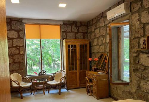 a room with a sink and a table and chairs at Azoyan Holiday Resort in Sisian