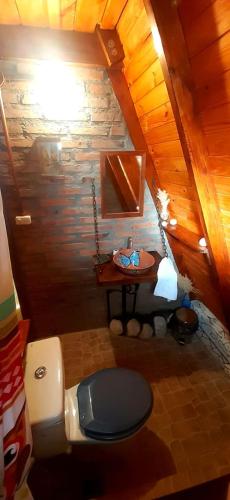 an overhead view of a bathroom with a toilet and a table at Cabañas "Los Elementos", San Carlos, Salta, in San Carlos