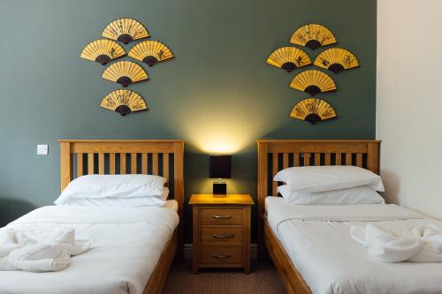 two beds sitting next to each other in a room at The Imperial Dragon Hotel in Saundersfoot