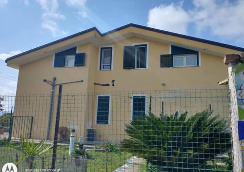a house with a fence in front of it at IDA S Apartament in Pontecagnano