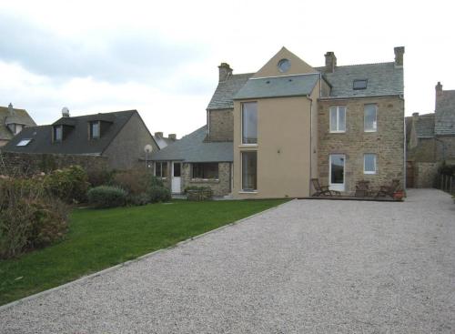 a large house with a driveway in front of it at GITE DU HABLE in Omonville-la-Rogue