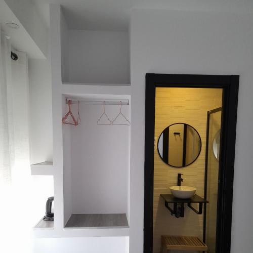 a bathroom with a mirror and a sink at CH Bueno in Madrid