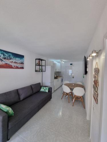 a living room with a couch and a table at Torres del Sol 12th floor Teide and Atlantic view - Las Americas in Playa de las Americas