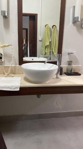 a bathroom with a large white sink and a mirror at Colonial cocoon studio in La Gaulette