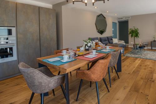 a dining room and living room with a wooden table and chairs at Deluxe VILLA GRAZIELLA 200 M FROM THE BEACH in Èze