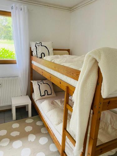 two bunk beds in a room with a window at Dat Blockhus am Diek in Dorum-Neufeld