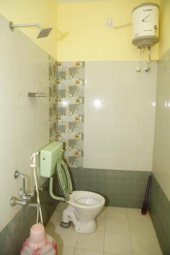 a bathroom with a toilet and a water tank at Ranga Residency in Mayiladuthurai