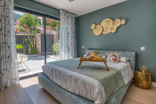 a bedroom with a bed with a table on it at Deluxe VILLA GRAZIELLA 200 M FROM THE BEACH in Èze