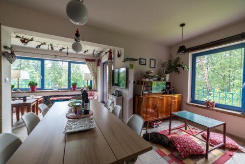 a kitchen and dining room with a wooden table at Apartamenty Lavender Hill in Wisła