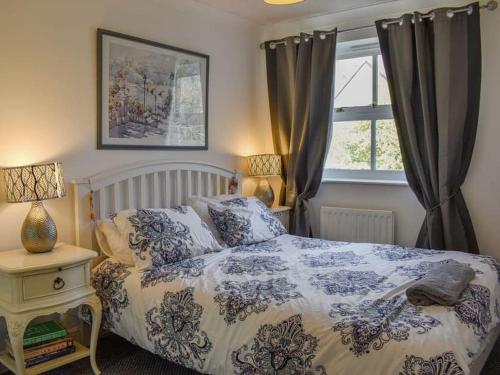 a bedroom with a bed and a window at Riverside in Kent
