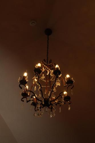 a chandelier is hanging from a ceiling at Hotel Boutique Vila 8 in Durrës