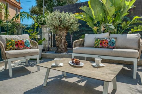 a patio with a coffee table and a couch and chairs at Deluxe VILLA GRAZIELLA 200 M FROM THE BEACH in Èze