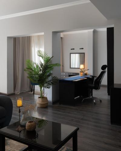 an office with a desk and a chair and a table at Assiut Cement Hotel in Asyut