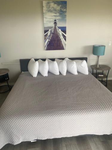 a bedroom with a large bed with white pillows at On the Beach Motel in Old Orchard Beach
