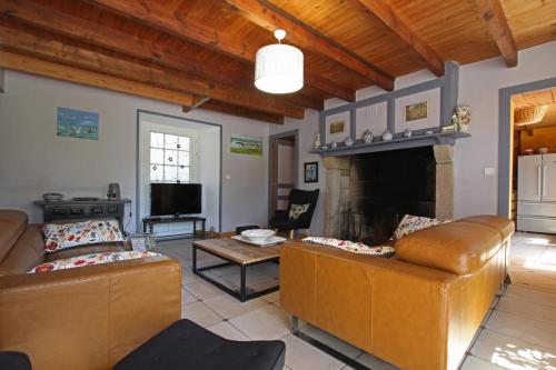 a living room with two couches and a fireplace at gite des vieilles rues in Omonville-la-Rogue