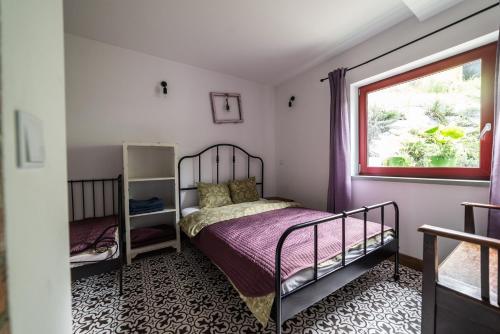 a bedroom with a bed and a window at Apartamenty Lavender Hill in Wisła