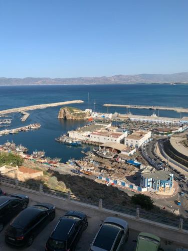 a parking lot with cars parked next to a harbor at Almarsa1 in Al Hoceïma