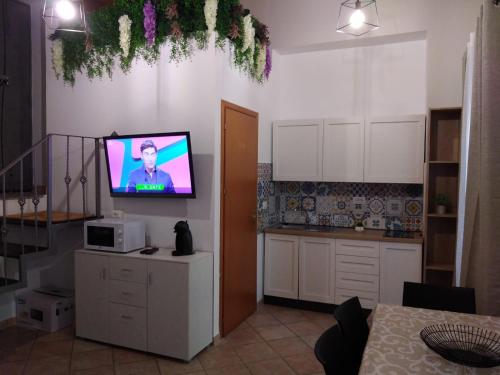 a kitchen with a flat screen tv on the wall at Casa Ruicella in Crotone