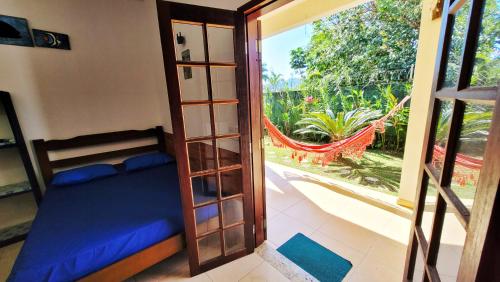 a bedroom with a bunk bed and a door to a balcony at Bardul´s House in Ubatuba