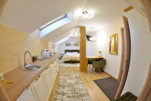 a kitchen with a sink and a bed in a room at Magic Five - Cazare Reghin *** in Reghin