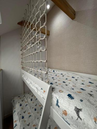 a bedroom with a bunk bed with a ladder at Norda Resort in Dębki