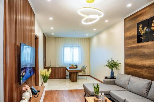 a living room with a couch and a tv at The King Hotel - Condotel Thai Nguyen in Thái Nguyên