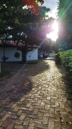 a stone driveway with the sun setting in the background at Villa Alejandra in Girardot