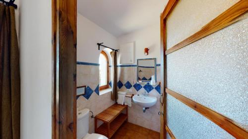 a small bathroom with a sink and a toilet at El Palomar de la Breña in Barbate