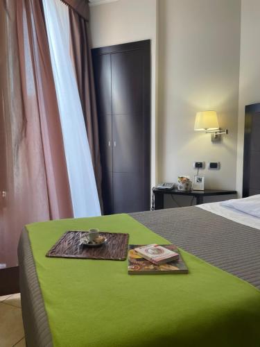 a hotel room with a bed with a tray on it at Cassisi Hotel in Milazzo