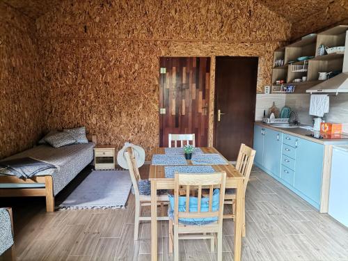 a kitchen and dining room with a table and chairs at Kutak na Drini in Ljubovija