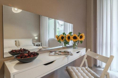 a bathroom with a mirror and a table with a bowl of fruit at WILLY-ANDON APARTMENT in Varna City