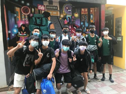 a group of boys wearing masks posing for a picture at mydeer backpacker in Tainan