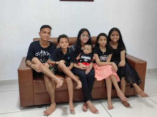 a group of people sitting on a couch at Bachan's Casa in Cherai Beach