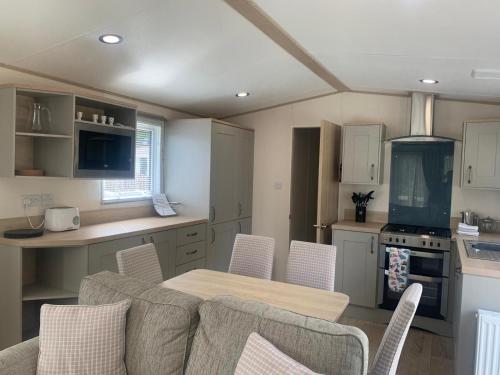 a kitchen and dining room with a table and chairs at Feorag Lodge in Aviemore