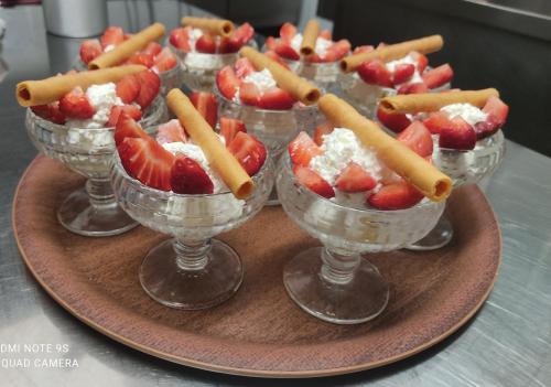 a group of desserts in bowls on a plate at Hôtel Le Pommeil in Guéret