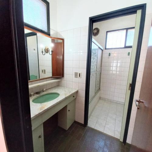 a bathroom with a sink and a mirror and a shower at Del Sol in General Rodríguez