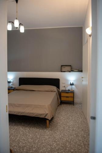 a bedroom with a bed and two night stands in a room at U'Panare in Taranto