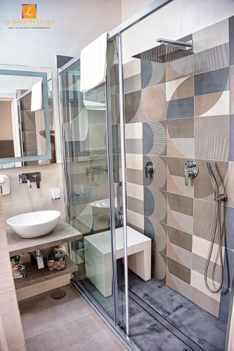 a bathroom with a glass shower and a sink at La maison di Lea in Gaeta
