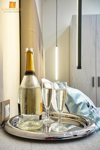 a bottle of champagne and two glasses on a tray at La maison di Lea in Gaeta
