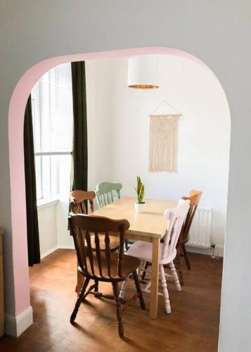 a dining room with a table and chairs at Light & Spacious Loch Lomond Apartment in Alexandria