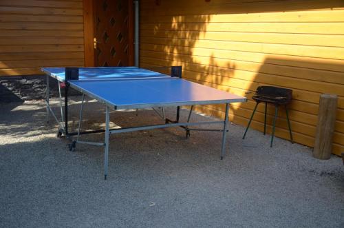 a blue ping pong table sitting next to a building at Châlet Caletti in Muhlbach-sur-Bruche