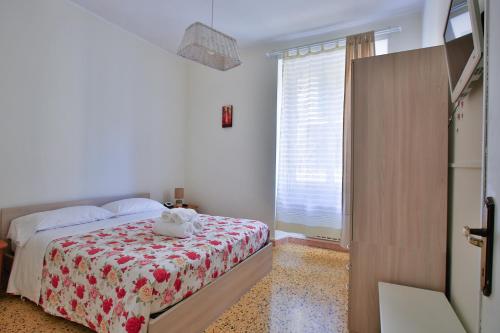a bedroom with a bed with a stuffed animal on it at Ca Lorelei in Riomaggiore
