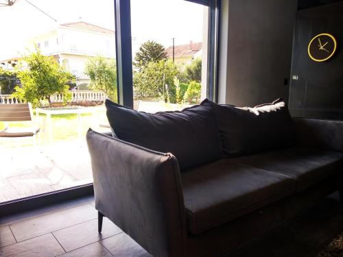 a leather couch in a room with a large window at House of Silence in Trogir