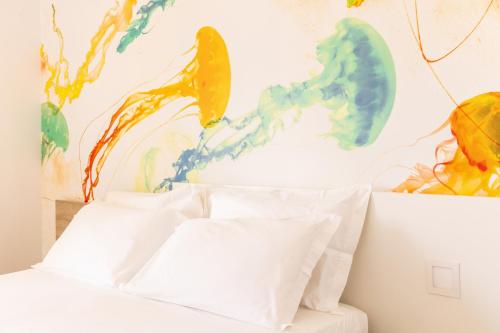 a bedroom with three white pillows on a bed at Luna Minoica Suites and Apartments in Montallegro