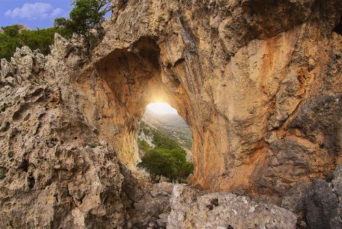 an opening in the side of a rocky mountain at Apartments Gonies - Artemis in Goníai